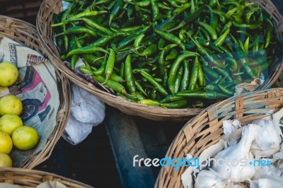 Baskets Full Of Peppers, Garlic, And Lemons Stock Photo