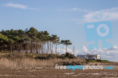 Beach And Cliffs In Quarteira Stock Photo