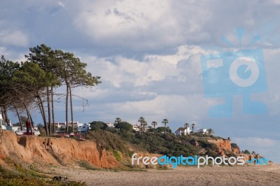 Beach And Cliffs In Quarteira Stock Photo