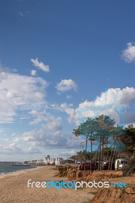 Beach And Cliffs In Quarteira Stock Photo