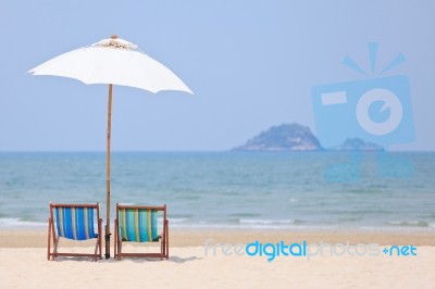 Beach Chairs And White Umbrella Stock Photo