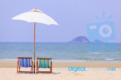 Beach Chairs And White Umbrella Stock Photo