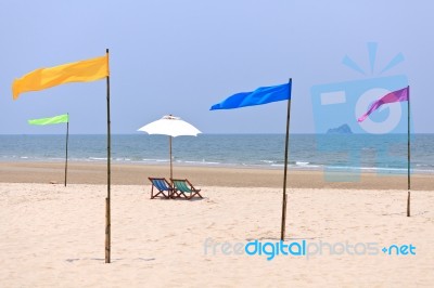 Beach Chairs And White Umbrella Stock Photo