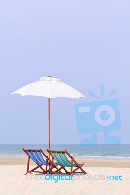 Beach Chairs And White Umbrella Stock Photo