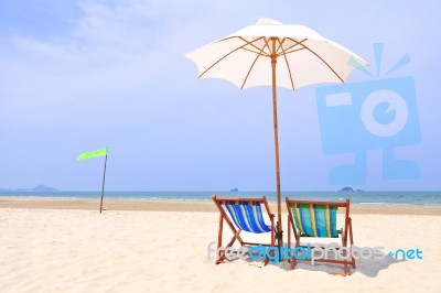 Beach Chairs And White Umbrella Stock Photo