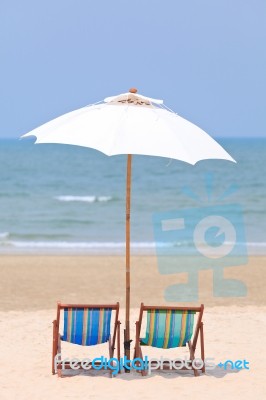 Beach Chairs And White Umbrella Stock Photo