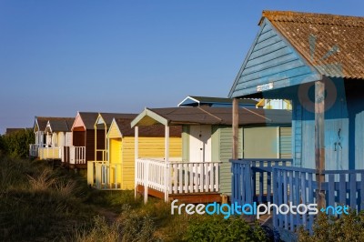 Beach Huts Bathed In Warm Evening Sunlight Stock Photo