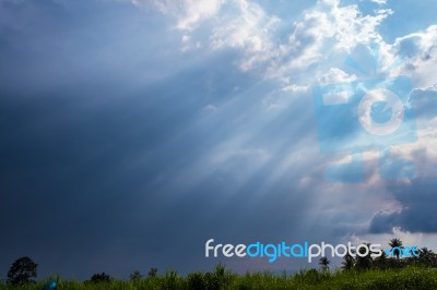 Beam Of Sunlight Behind Dark Clouds Stock Photo