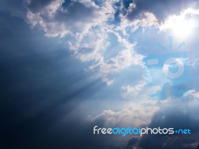 Beam Of Sunlight Behind Dark Clouds Stock Photo