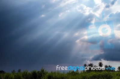 Beam Of Sunlight Behind Dark Clouds Stock Photo