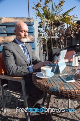 Bearded Businessman With Working Outside The Office Stock Photo