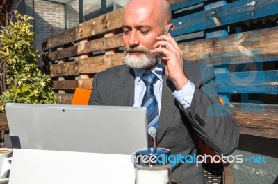 Bearded Businessman With Working Outside The Office Stock Photo