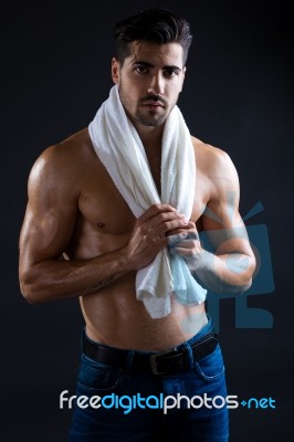 Beautiful And Muscular Man In Dark Background Stock Photo