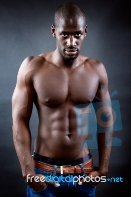 Beautiful And Muscular Man In Dark Background Stock Photo