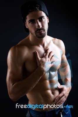 Beautiful And Muscular Man In Dark Background Stock Photo