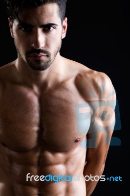 Beautiful And Muscular Man In Dark Background Stock Photo