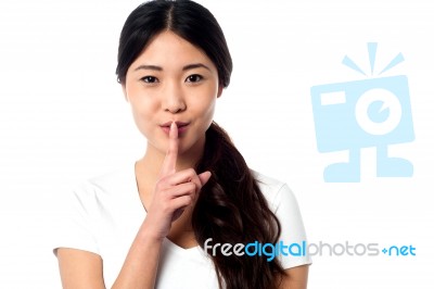 Beautiful Asian Girl Gesturing Silence Stock Photo