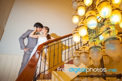 Beautiful Asian Young Bride And Groom Kissing Stock Photo