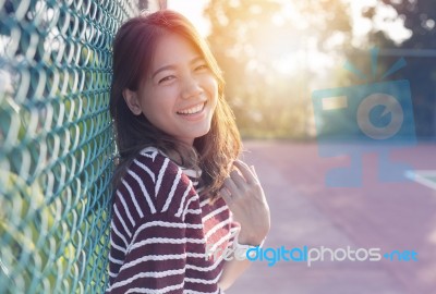 Beautiful Asian Younger Woman Laughing With Happiness Emotion And Sun Light Behind Stock Photo