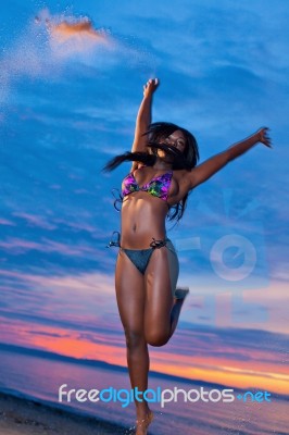 Beautiful Black African American Woman Jumping On The Beach At S… Stock Photo