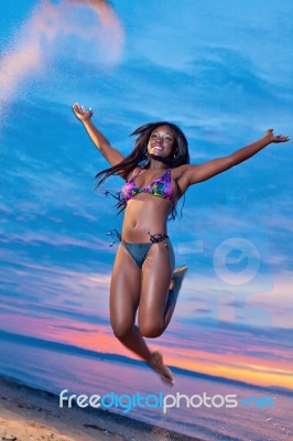 Beautiful Black African American Woman Jumping On The Beach At S… Stock Photo