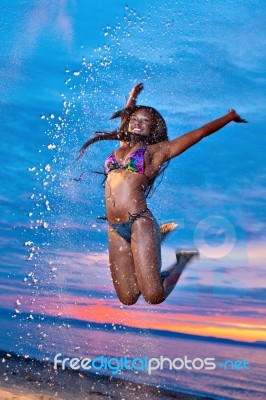 Beautiful Black African American Woman Jumping On The Beach At S… Stock Photo