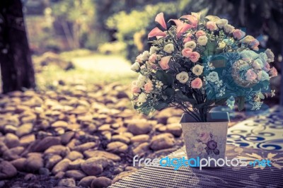 Beautiful Bouquet Of Artificial Flowers In A Ceramic Vase On Park Stock Photo