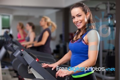 Beautiful Brunette On A Treadmill Stock Photo