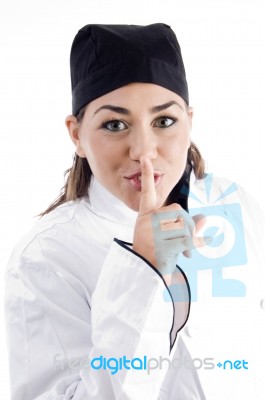 Beautiful Chef Shushing With Finger Stock Photo