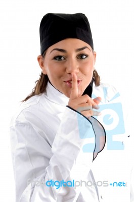 Beautiful Chef Shushing With Finger Stock Photo