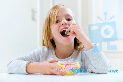 Beautiful Child Eating Sweets At Home Stock Photo