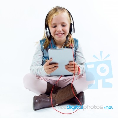 Beautiful Child Listening To Music With Digital Tablet Stock Photo