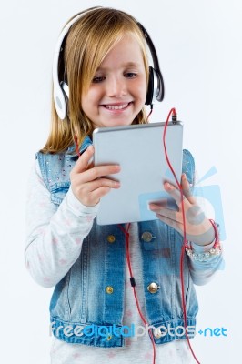 Beautiful Child Listening To Music With Digital Tablet Stock Photo