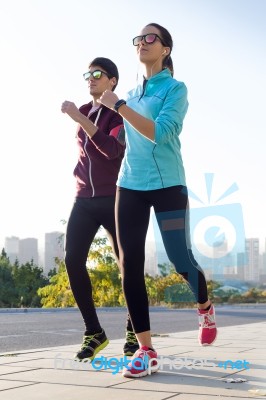 Beautiful Couple Running In The Street Stock Photo