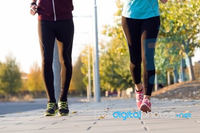 Beautiful Couple Running In The Street Stock Photo