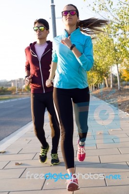 Beautiful Couple Running In The Street Stock Photo