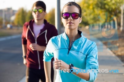 Beautiful Couple Running In The Street Stock Photo