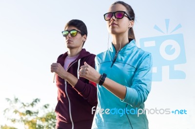 Beautiful Couple Running In The Street Stock Photo