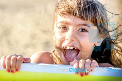 Beautiful Eight Year Old Girl Smiling On The Beach Stock Photo