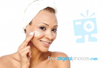 Beautiful Female Applying Moisturizer Stock Photo