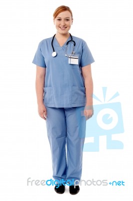 Beautiful Female Doctor Standing Against White Stock Photo