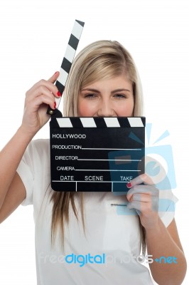 Beautiful Female With Clapperboard. It's Showtime Stock Photo