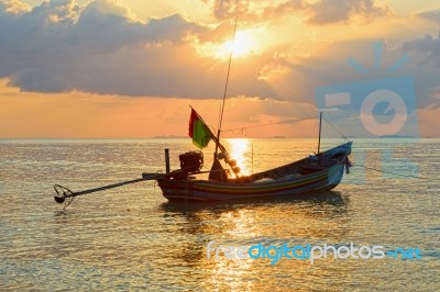 Beautiful  Fishing Boat Floating With Golden Sunrise Light Backg… Stock Photo