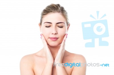 Beautiful Girl Applying Lotion On Her Face Stock Photo