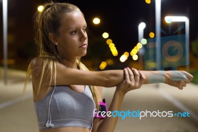 Beautiful Girl Doing Stretching At Night Stock Photo