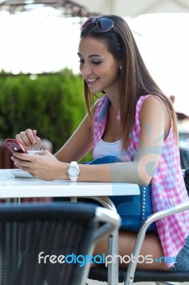 Beautiful Girl Drinking Coffee And Texting With Mobile Phone Stock Photo