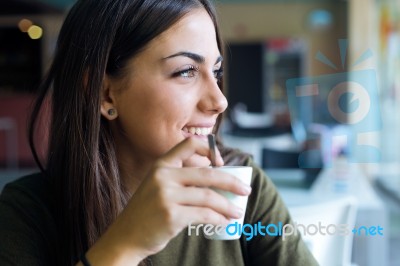 Beautiful Girl Drinking Coffee Sitting Indoor In Urban Cafe Stock Photo