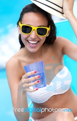 Beautiful Girl Drinking Water At The Swimming Pool Stock Photo