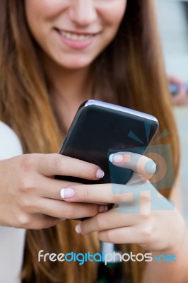 Beautiful Girl Having Fun With Smartphone After Class Stock Photo