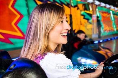 Beautiful Girl In An Electric Bumper Car At Amusement Park Stock Photo